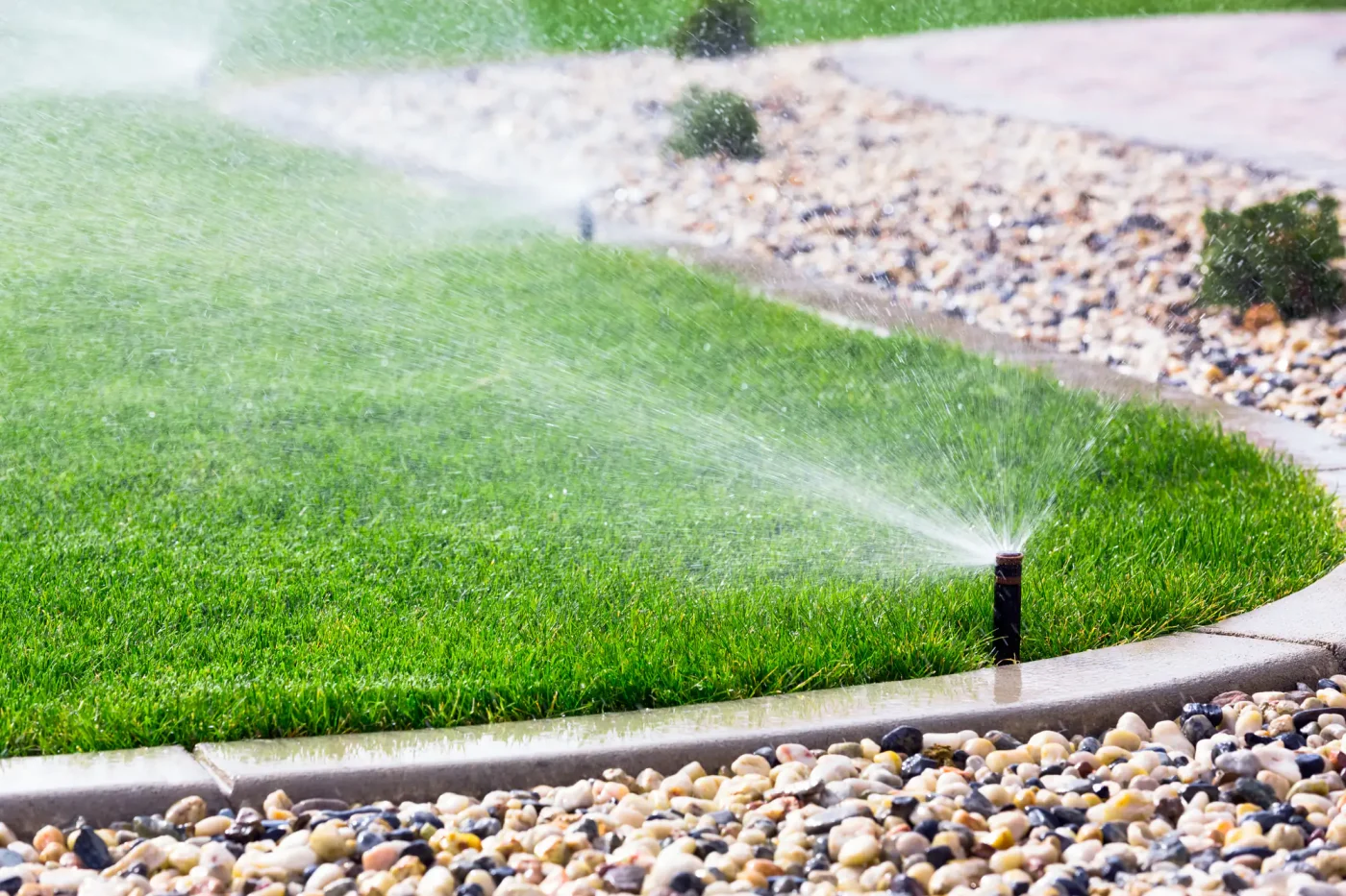 A lawn sprinkler waters lush green grass, ideal for sprinkler installation in Palm Beach County, FL.
